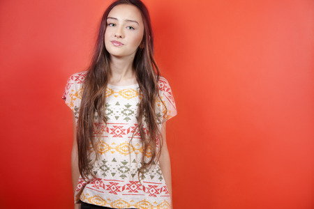 Fashionable young brunette teenager girl posing in studio, looking at camera.の写真素材