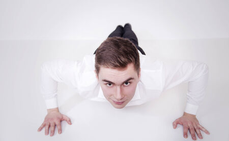 Smiling young businessman exercising in work.の写真素材