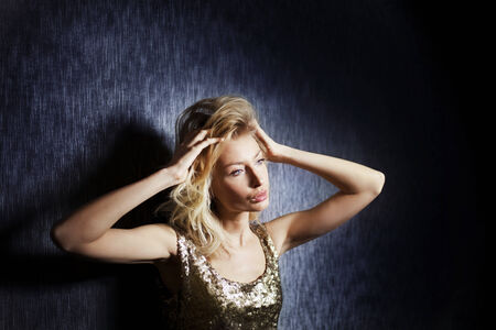 Portrait of beautiful young blonde fashionable woman posing , looking away.の写真素材