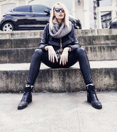 Fashionable blonde young woman in sunglasses sitting  Car on background  の写真素材