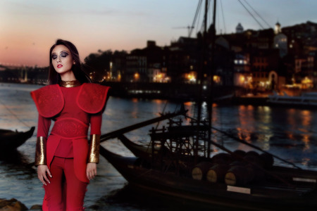 Beautiful attractive brunette woman posing wearing red modern clothes. Riverbank.の写真素材