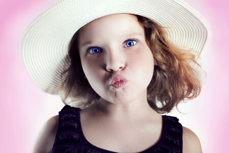 Portrait of little funny girl looking at camera.の写真素材