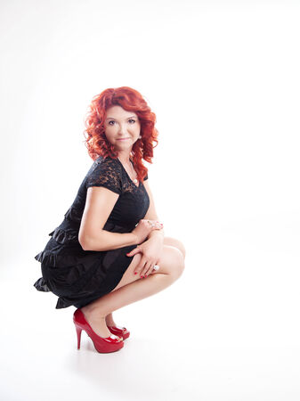 Adult beautiful redhead woman posing over white background.の写真素材