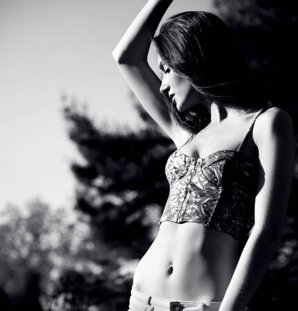Portrait of beautiful brunette girl posing outdoor with closed eyes.の写真素材