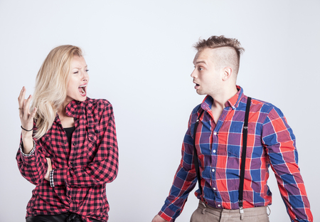 Young couple shouting during the quarrel. Studio shot.の写真素材
