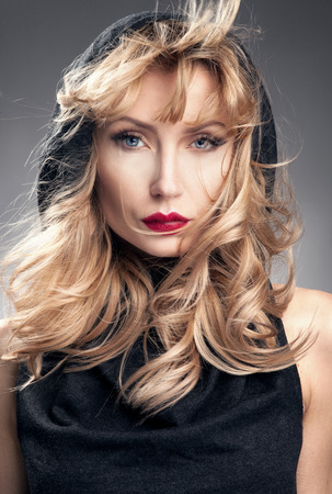 Beauty portrait of blonde elegant woman. Girl looking at camera. Long curly hair.の写真素材