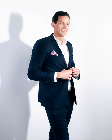 Fashionable young handsome man posing in studio, smiling.の写真素材