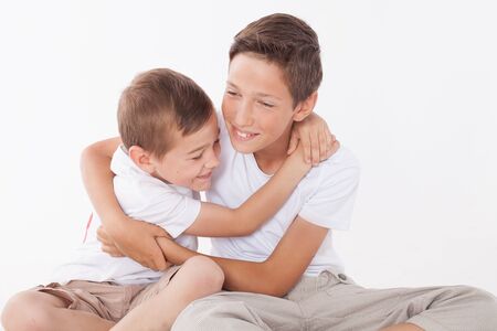 Two brothers posing at home, hugging. Family portrait.の写真素材
