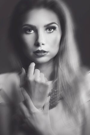 Closeup beauty portrait of blonde young woman. Girl looking at camera.の写真素材