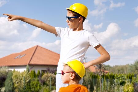 Two young boys as an architects, working. Outdoor photo.の写真素材