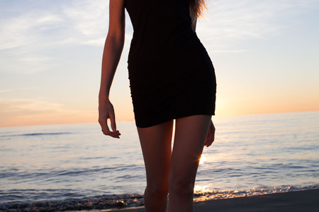 Carefree young woman dancing on the beach. Summer photo. Sunset.の写真素材