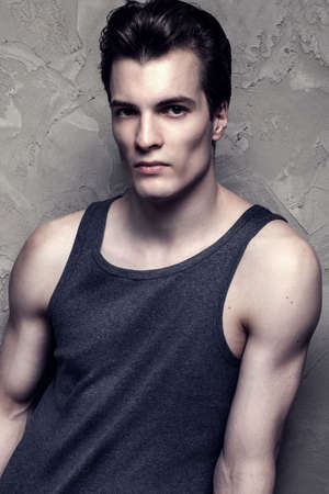 Young handsome fashionable man posing in studio.の写真素材