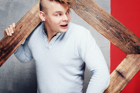 Photo of young happy man with funky hairstyle. Guy looking at camera, smiling.の写真素材