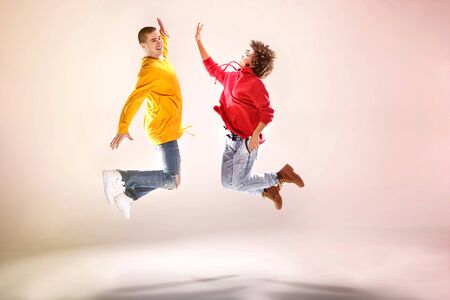 Young girl with afro dancing with boy, modern dancers.