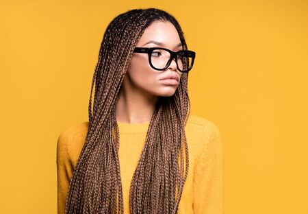 Young beautiful african american teenager girl with long braids hairstyle and fashionable...