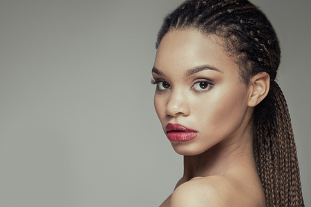 Beauty portrait of young african american girl, looking at camera.の写真素材