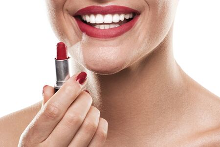 Closeup photo of beautiful red lips and lipstick. Smiling woman.の写真素材