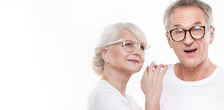 Beautiful happy senior couple posing together , wearing fashionable eyeglasses.