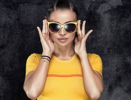 Fashionable beautiful brunette woman posing, summer style photo.
