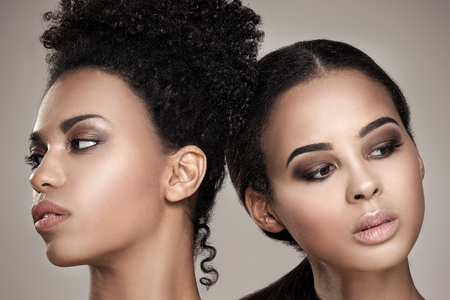 Two beauty young african american women. Closeup portrait of beautiful girls with natural makeup.の写真素材