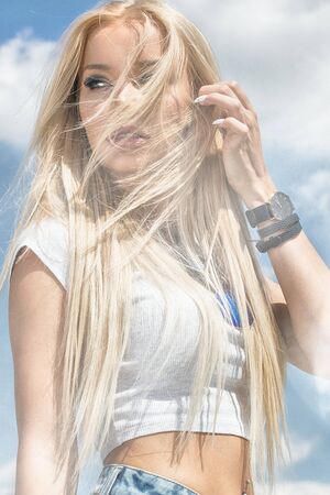 Portrait of blonde casucasian woman with long hair and glamour makeup.の写真素材