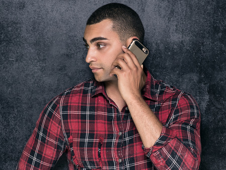 Photo of young handsome african american man in checkered shirt.