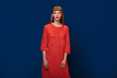 Elegant redhead woman wearing black fashionable earrings. Girl with glamour makeup.の写真素材