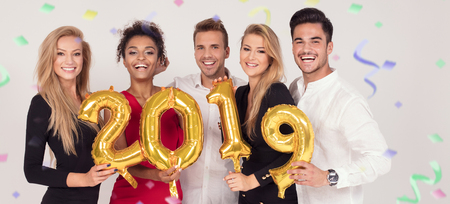 Group of party people celebrating New years eve party, smiling to the camera.の写真素材