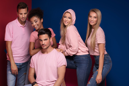 Group of young multi-ethnic attractive people smiling and having fun together, posing on colorful...