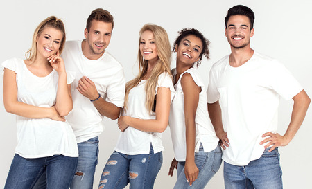 Group of young multi-ethnic attractive people wearing white shirts, smiling and having fun together,...