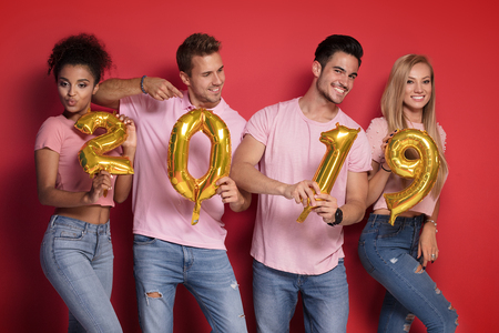 Group of party people celebrating New years eve party, smiling to the camera.の写真素材