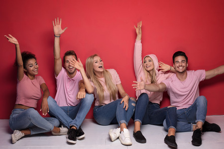 Young multi-ethnic attractive people smiling and spending time together, posing on colorful...