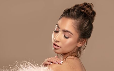 Beauty portrait of elegant young brunette girl wearing pink eco fur. Attractive woman in delicate...