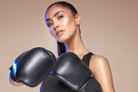 Female fighter. Sexy woman in boxing gloves. Sportswoman. Sport, boxing and fitness concept.