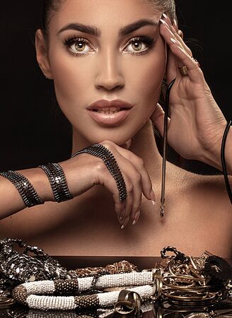 Beautiful woman with a lot of jewelry . Beauty and accessories.の写真素材