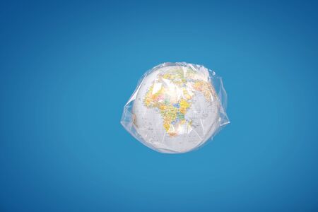 A world globe wrapped in plastic. Plastic contamination or protection against the epidemic...