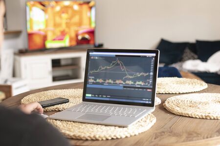Photo of modern notebook and smart phone on the wooden table. Home office concept during quarantine.の写真素材
