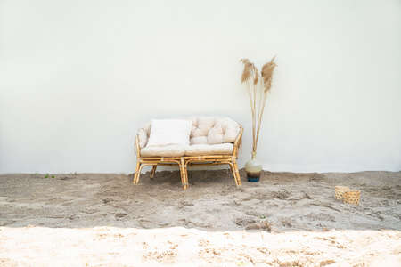 Boho eco styled beach essentials on sand by sea. Romantic picnic for couple on the beach.の写真素材