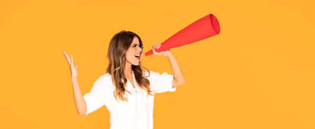 Photo of young shouting caucasian woman on yellow studio background. Stylish, trendy look. Beautiful...