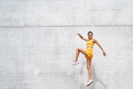 Positive caucasian woman in sportswear workout, outdoor sport. Healthy lifestyle concept.の写真素材