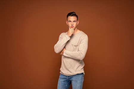 Young handsome man wearing fashionable clothes, looking at camera. A lot of copy space.