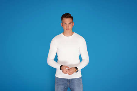 Young handsome man wearing fashionable clothes, looking at camera. A lot of copy space.