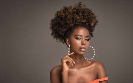 Beauty portrait of woman with afro posing in studio.の写真素材