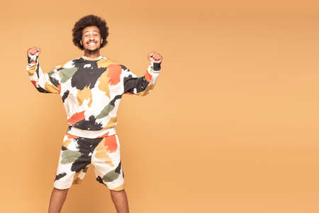 Joyful Young Afro Man Having Fun Jumping In Air.