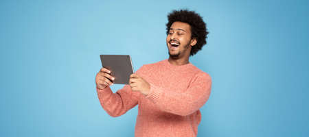 Happy African Man Holding Tablet Computer and smiling.の写真素材