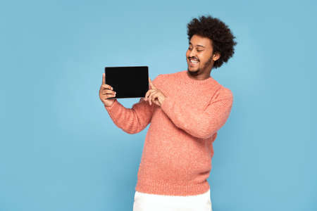 Happy African Man Holding Tablet Computer and smiling.の写真素材