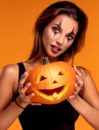 Halloween Sexy Girl wearing costume and joker's makeup.の写真素材