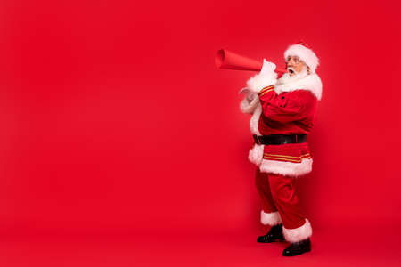 Christmas are coming! Real Santa Claus screaming through megaphone about xmas.の写真素材