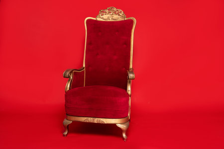 Luxurious Santa Claus throne standing over red studio background.の写真素材