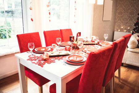 Photo of Christmas holidays red table setting concept. Festive dinner at home.の写真素材
